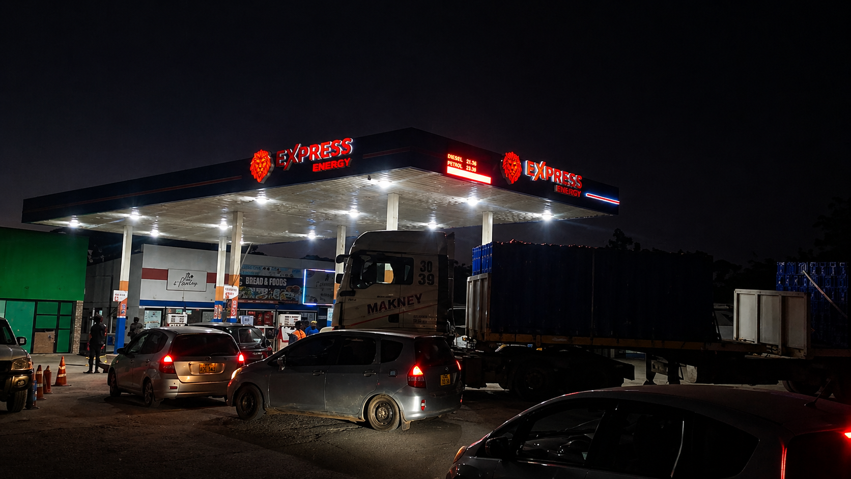 Express Energy forecourt at night with cars and a haulage truck refueling